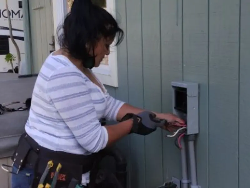 Licensed electrician wiring an exterior subpanel in Mack