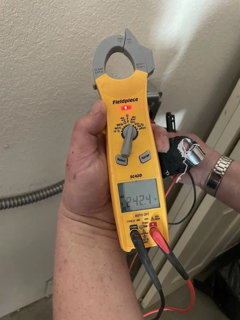 Voltage testing with clamp meter during Ceiling Fan Installation in Mack